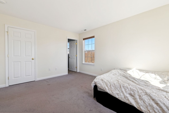 carpeted bedroom featuring visible vents and baseboards