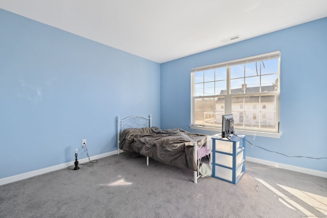 bedroom with visible vents, carpet flooring, and baseboards