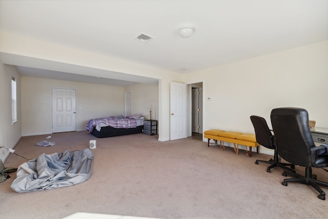 carpeted bedroom with visible vents and baseboards