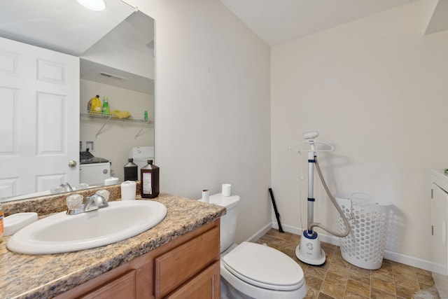 bathroom with visible vents, baseboards, toilet, and vanity