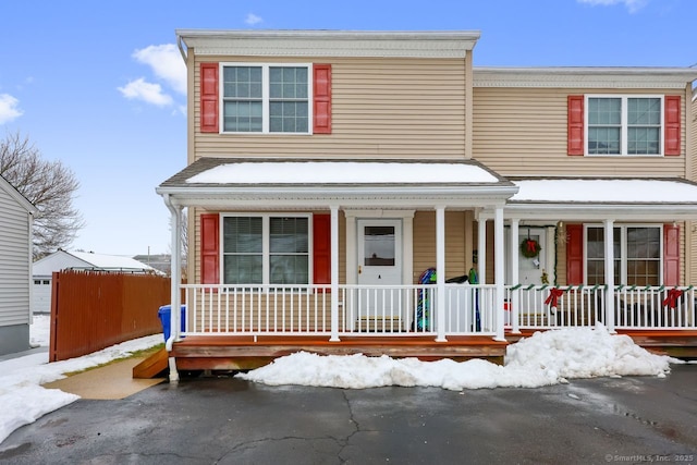 view of front of property with fence and a porch