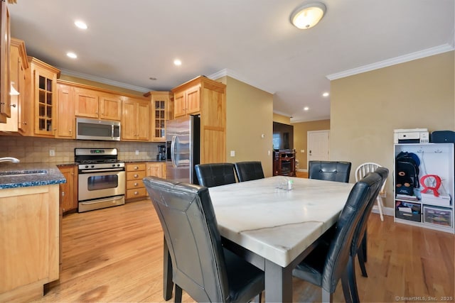 dining area with recessed lighting, light wood-type flooring, and crown molding