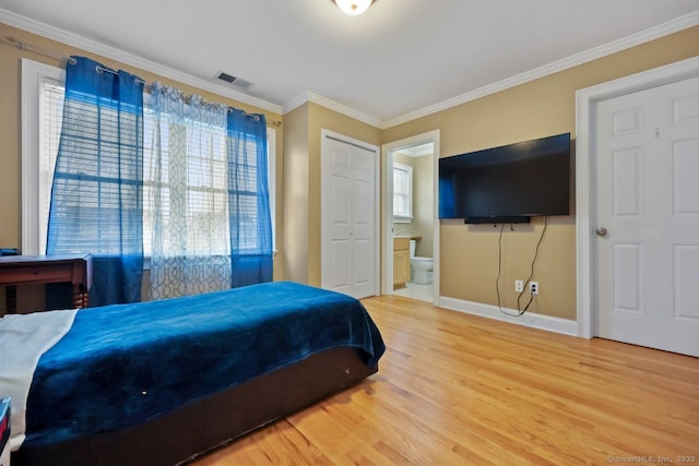 bedroom featuring crown molding, ensuite bath, visible vents, and light wood-style floors