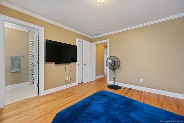 bedroom featuring ornamental molding, wood finished floors, and baseboards