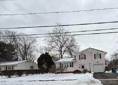 view of front of property with a garage and driveway