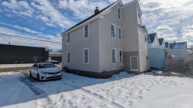 view of front facade featuring a chimney