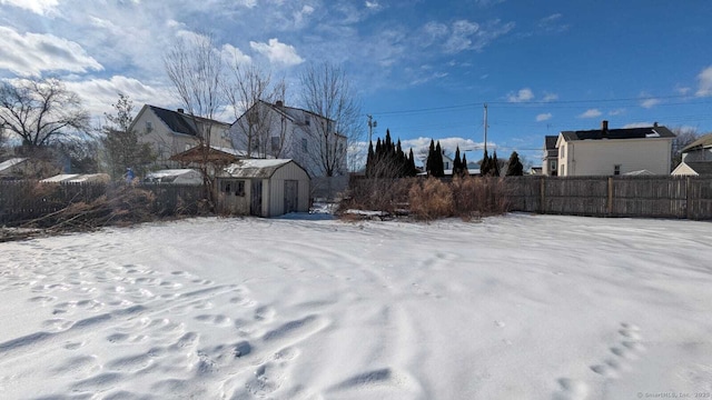 snowy yard with fence