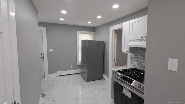 kitchen featuring light countertops, freestanding refrigerator, white cabinetry, under cabinet range hood, and stainless steel gas range oven
