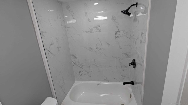 bathroom with shower / washtub combination and toilet