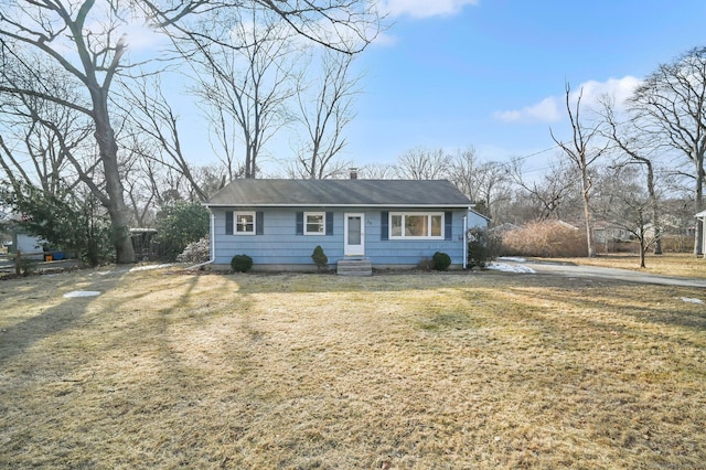 view of front of home with a front lawn and a chimney