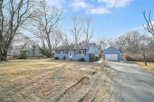 ranch-style home with an outbuilding, a detached garage, and a front yard