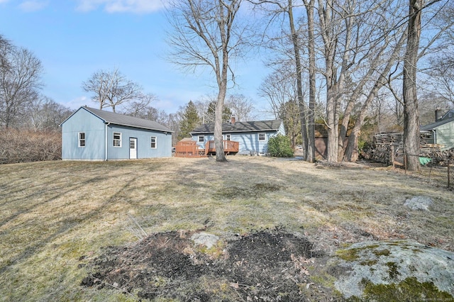 view of yard featuring an outdoor structure and a wooden deck