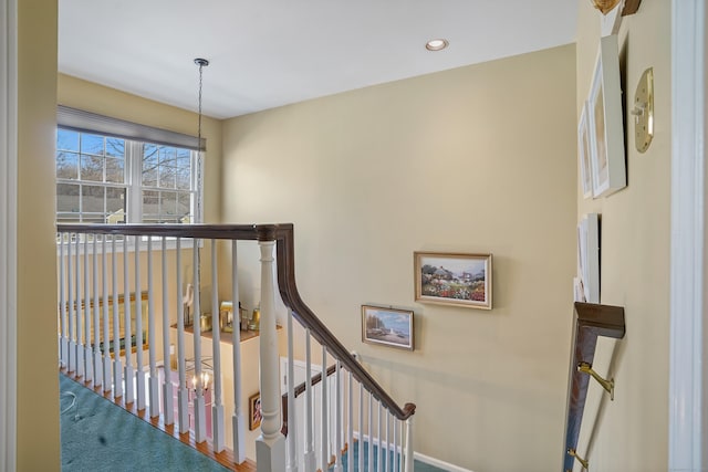 corridor featuring recessed lighting and an upstairs landing