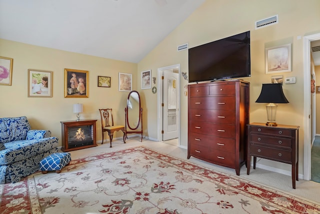 sitting room with lofted ceiling, light carpet, visible vents, and baseboards