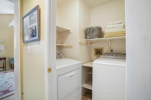 clothes washing area featuring laundry area and washing machine and clothes dryer