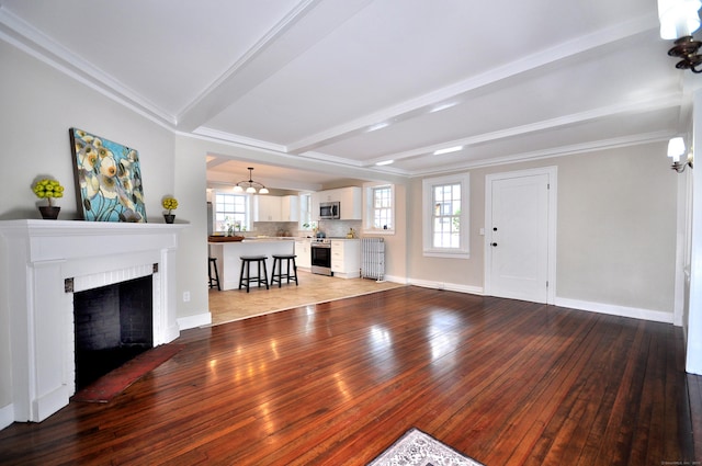 unfurnished living room with light wood finished floors, a fireplace, a wealth of natural light, and beam ceiling