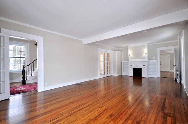 unfurnished living room featuring hardwood / wood-style flooring, baseboards, ornamental molding, stairway, and a brick fireplace