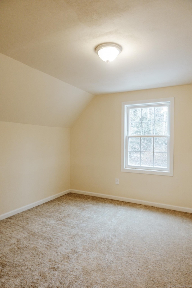 bonus room with lofted ceiling, carpet, and baseboards