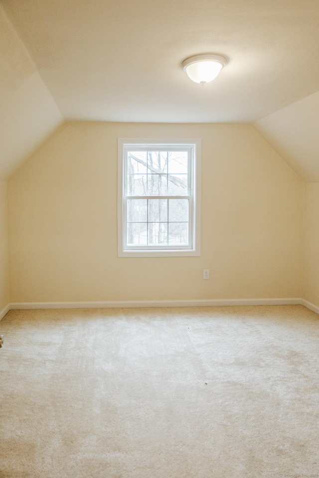 bonus room with carpet, vaulted ceiling, and baseboards