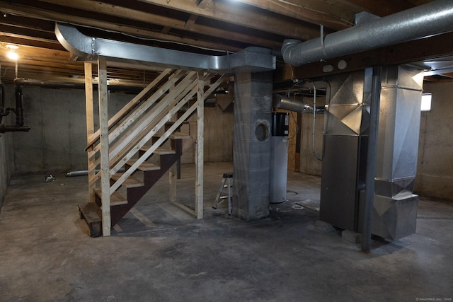 unfinished below grade area with gas water heater, heating unit, and stairs