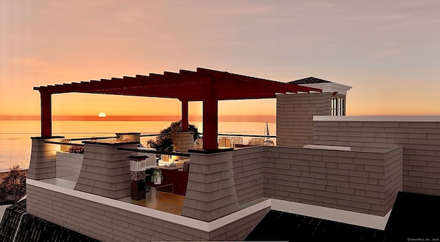 deck featuring a pergola and a water view