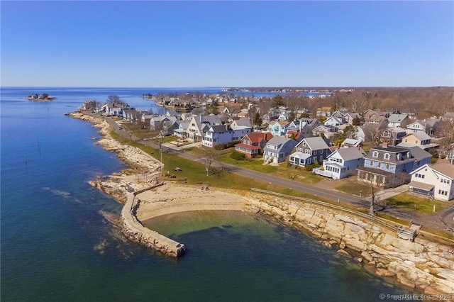 drone / aerial view with a water view and a residential view