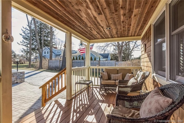 wooden deck featuring outdoor lounge area and fence