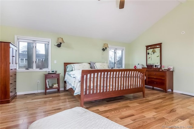 bedroom with lofted ceiling, ceiling fan, wood finished floors, and baseboards