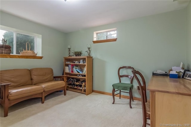 sitting room with light colored carpet and baseboards