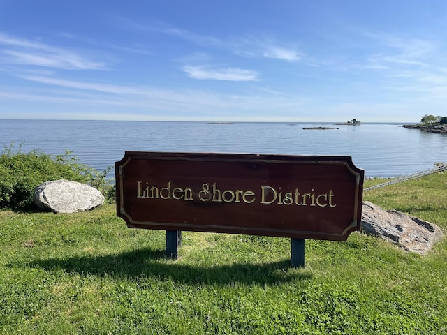 community / neighborhood sign featuring a water view