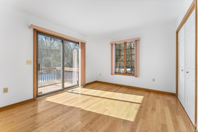 doorway featuring visible vents, baseboards, and wood finished floors