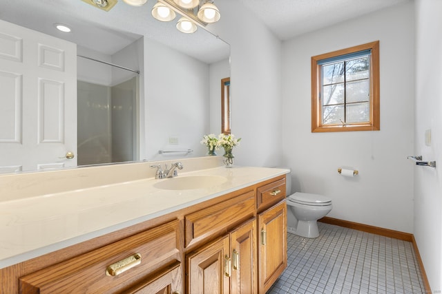 bathroom with a shower, toilet, vanity, baseboards, and tile patterned floors