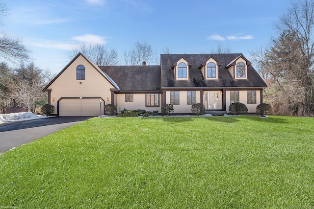 view of front facade with aphalt driveway, a front yard, and a garage