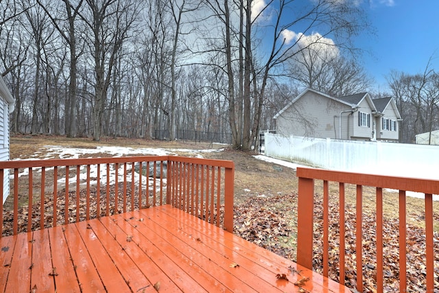 snow covered deck featuring fence