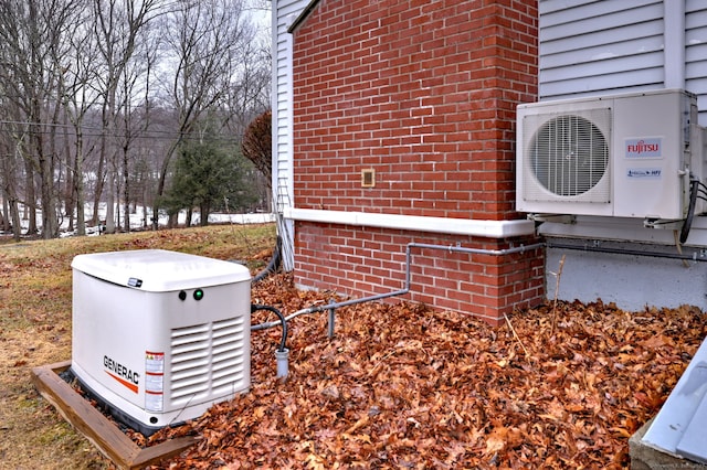 details featuring a power unit, brick siding, and ac unit