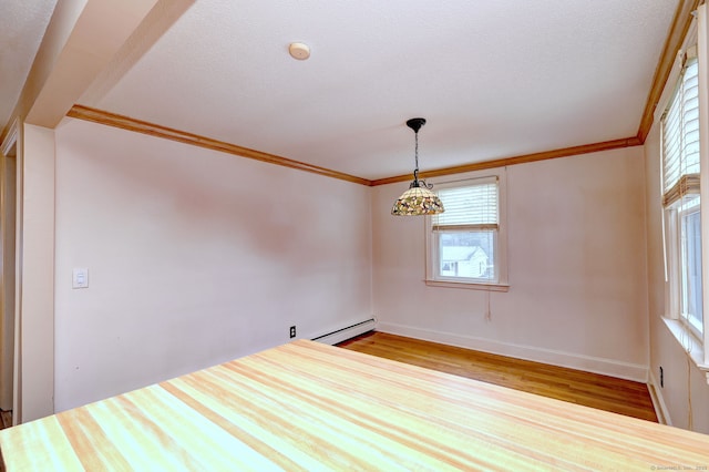 empty room featuring baseboards, baseboard heating, wood finished floors, and crown molding