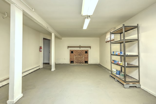 finished basement featuring a baseboard heating unit