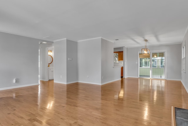 unfurnished living room with crown molding, baseboards, and light wood-style floors