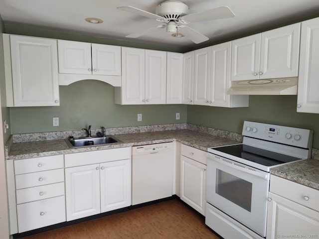 kitchen with white cabinetry, white appliances, under cabinet range hood, and a sink