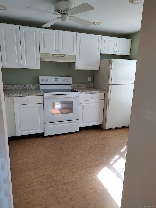 kitchen featuring white appliances, wood finished floors, ceiling fan, white cabinets, and under cabinet range hood