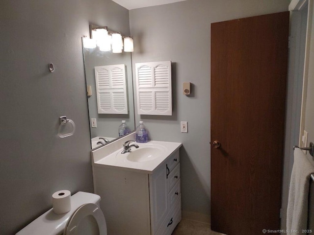 bathroom featuring toilet and vanity