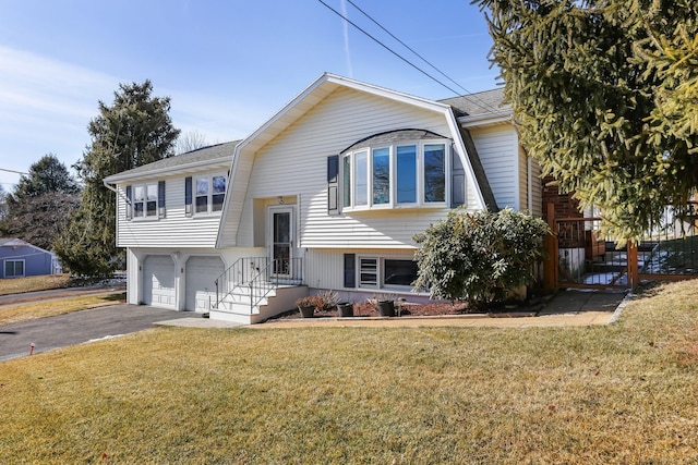 bi-level home with driveway, an attached garage, and a front lawn