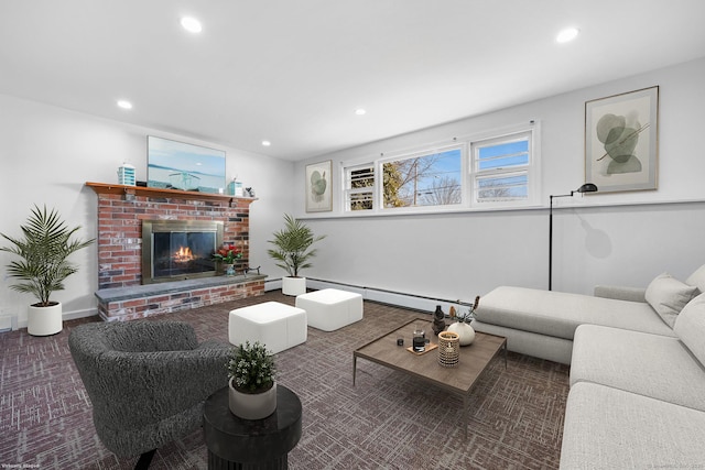 living room featuring a brick fireplace, a baseboard heating unit, and recessed lighting