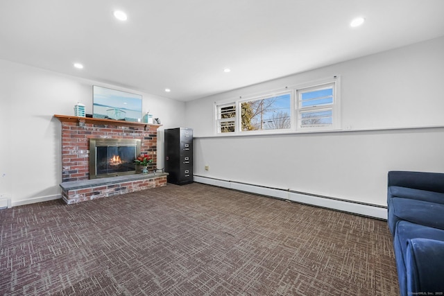 unfurnished living room with a baseboard heating unit, recessed lighting, a fireplace, and carpet