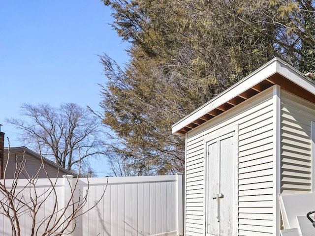 view of shed with fence