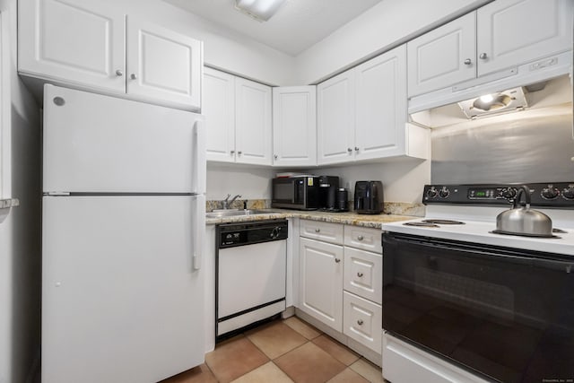 kitchen featuring white appliances, white cabinets, light countertops, a sink, and light tile patterned flooring