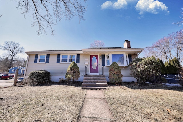 ranch-style house with entry steps and a chimney