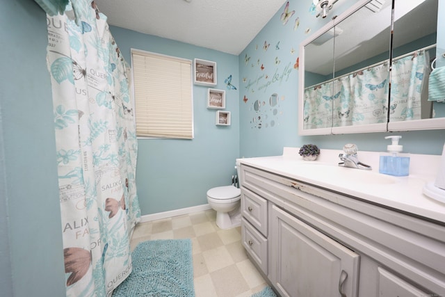 bathroom featuring baseboards, toilet, tile patterned floors, a textured ceiling, and vanity