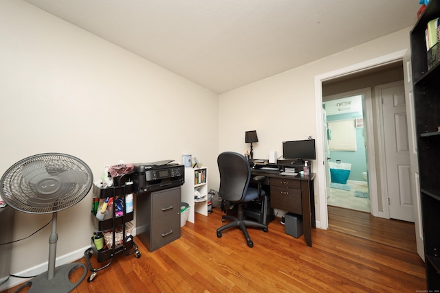 office space with baseboards and wood finished floors