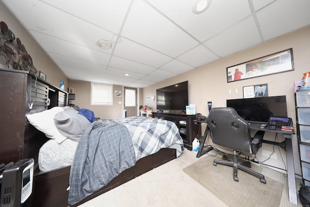 bedroom with a drop ceiling and carpet flooring